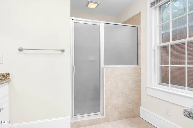 a bathroom with a glass shower door
