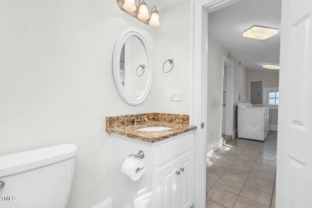 a bathroom with a sink a toilet and a mirror