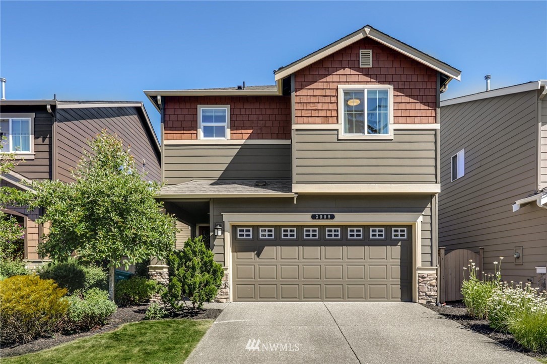 a front view of a house with a garage