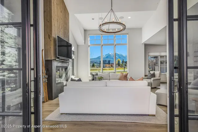 a living room with furniture and a kitchen view
