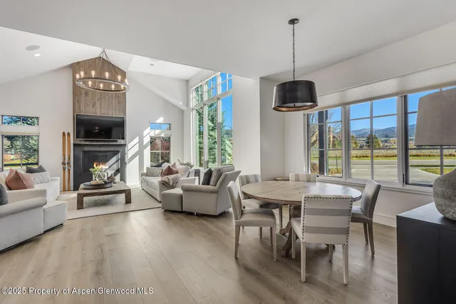 a living room with stainless steel appliances kitchen island granite countertop furniture and a view of kitchen
