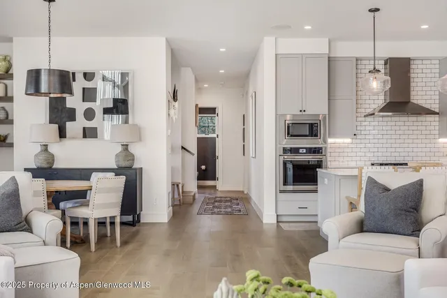 a large kitchen with a table and chairs