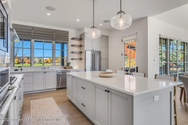 a kitchen with a table chairs and a stove