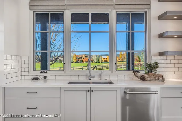 a spacious bedroom with a bed and large windows