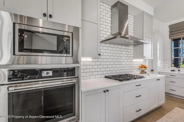 a bedroom with furniture and a large window