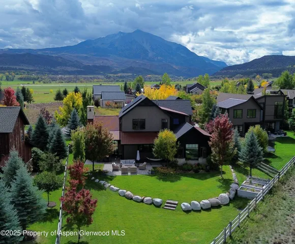 a front view of a house with yard and green space