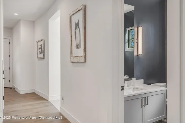 a bathroom with a granite countertop sink mirror and a shower
