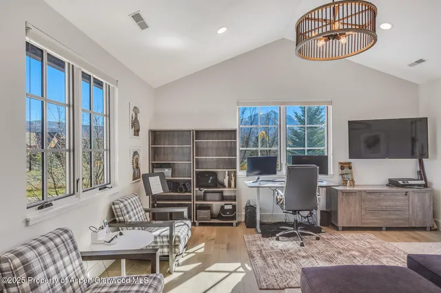 a view of a room with a couch and wooden floor