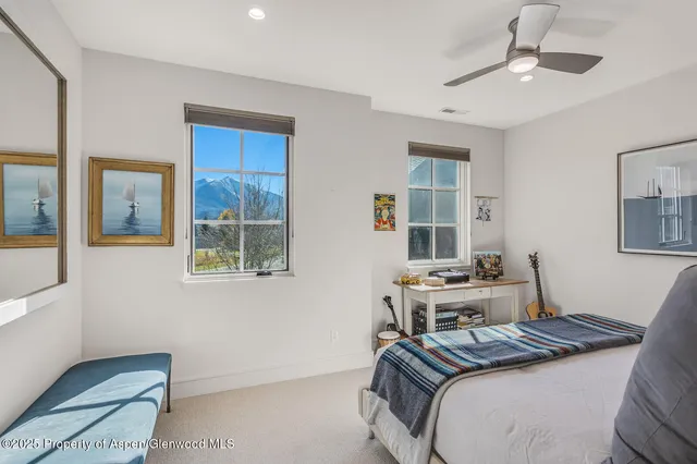 a bedroom with a rug and wooden floor