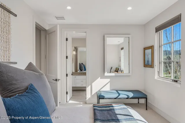 a bed sitting in a bedroom next to a window