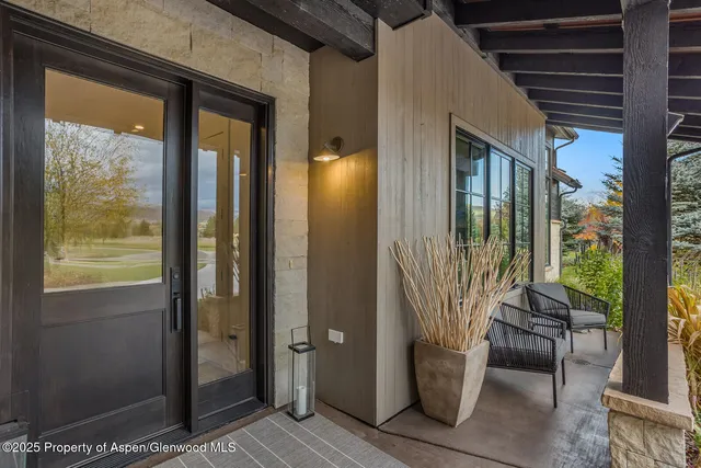 a view of an outdoor dining space with a table and chairs