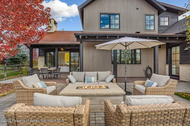 a large white kitchen with a large window and stainless steel appliances