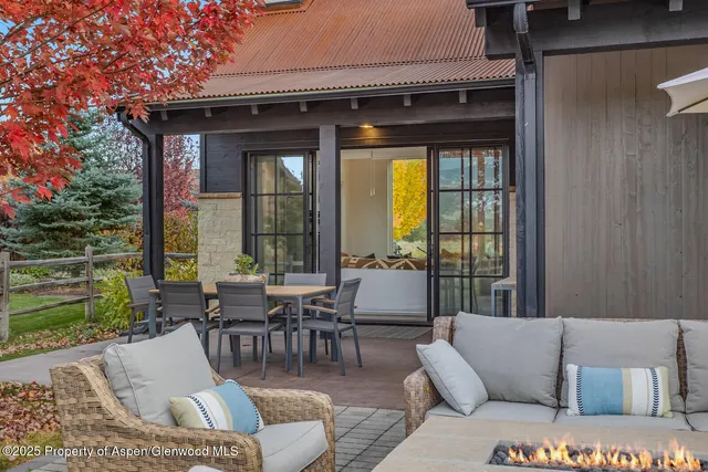 a living room with furniture a fireplace and a large window