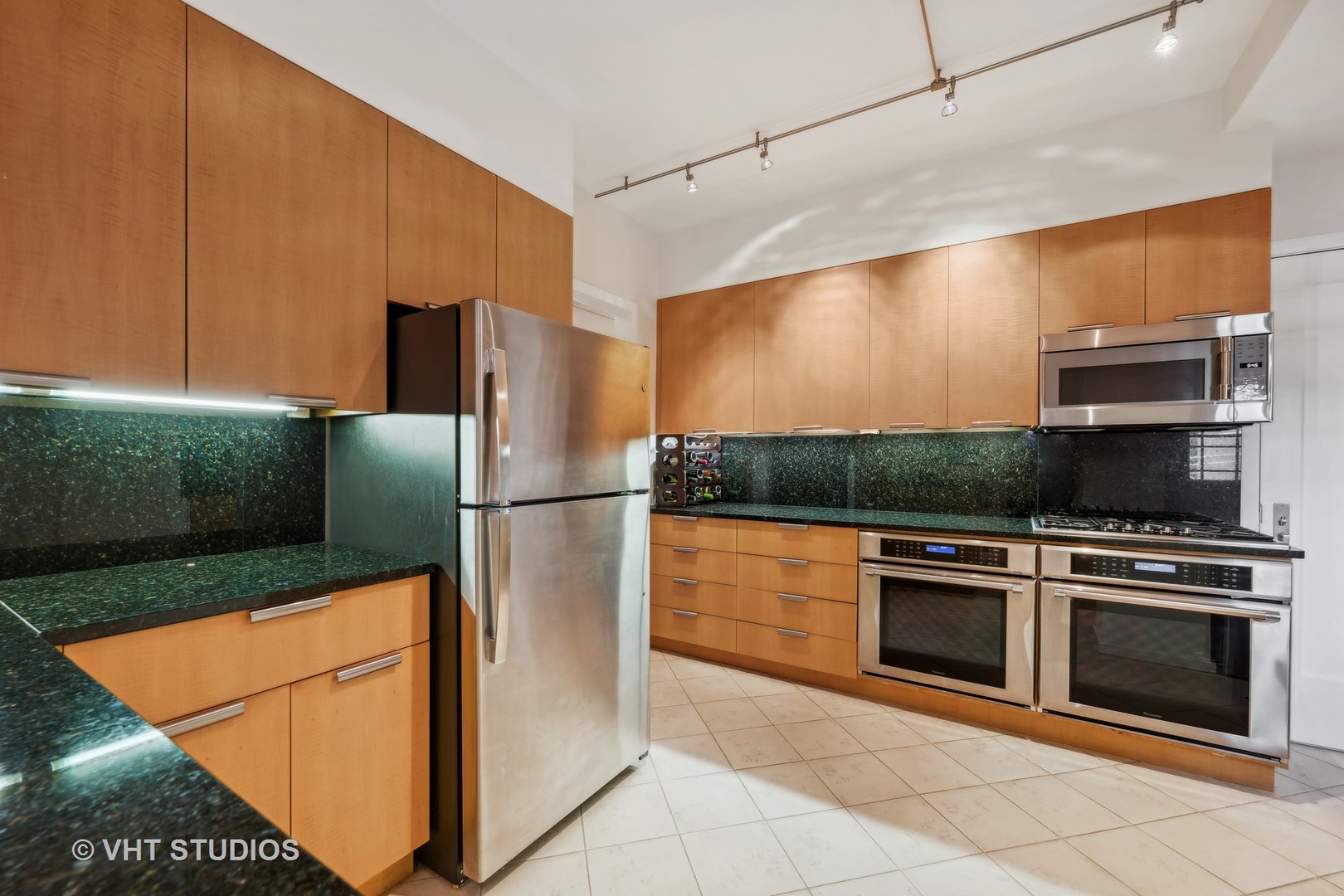 1426 Chicago Avenue, Unit 2N Evanston, IL 60201 - Photo 12 of 32 a kitchen with stainless steel appliances granite countertop a refrigerator and a stove