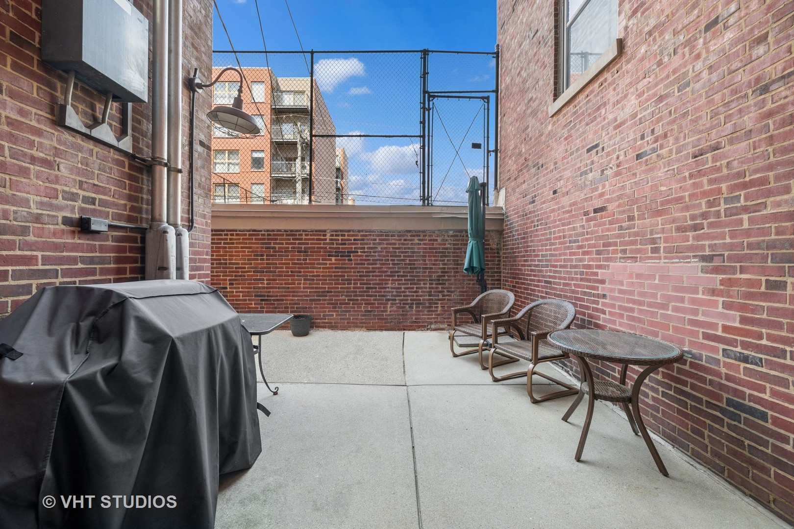 1426 Chicago Avenue, Unit 2N Evanston, IL 60201 - Photo 22 of 32 a backyard of a house with table and chairs