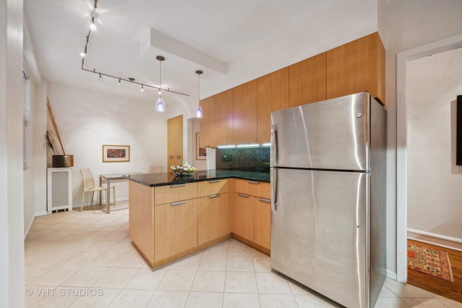 1426 Chicago Avenue, Unit 2N Evanston, IL 60201 - Photo 10 of 32 a kitchen with stainless steel appliances granite countertop a refrigerator and a sink