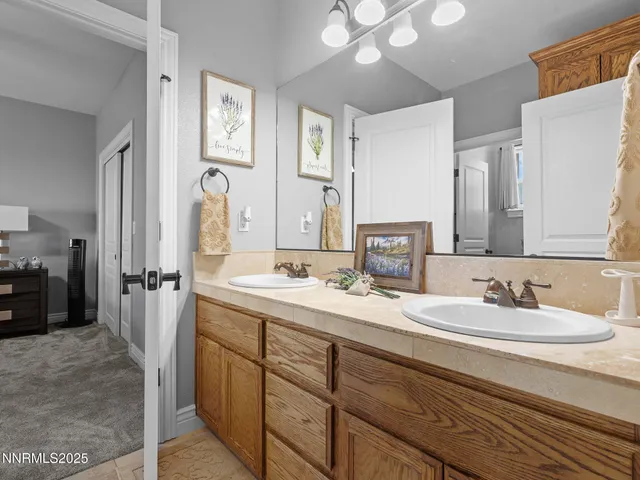 a bathroom with a double vanity sink and a mirror
