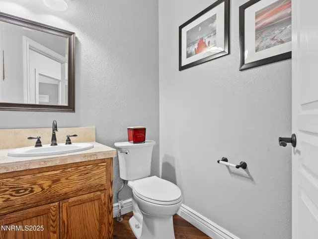 a bathroom with a sink mirror vanity and toilet
