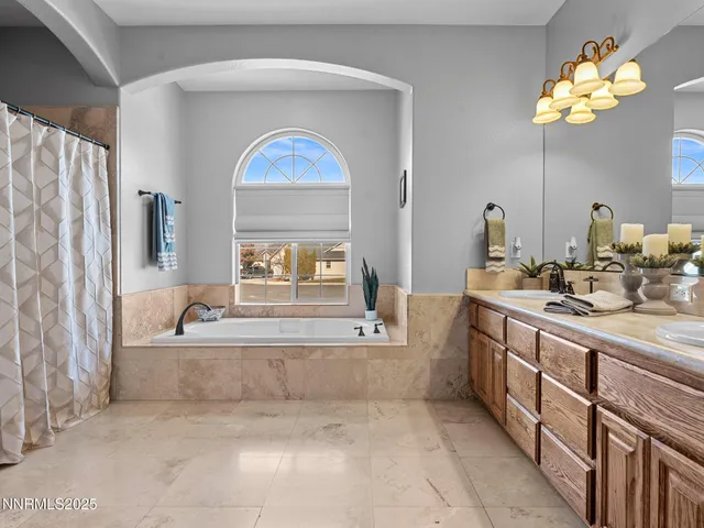 a bathroom with a tub sink and mirror