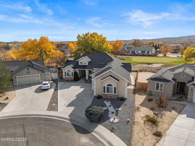 a view of a white house with a yard