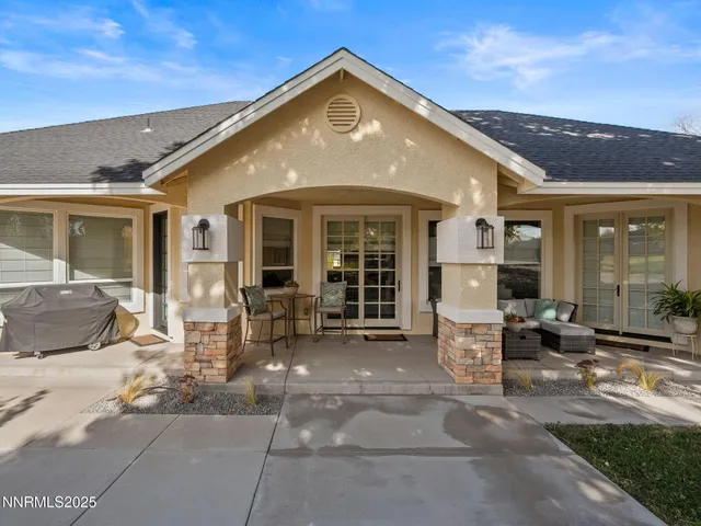 a front view of a house with outdoor seating