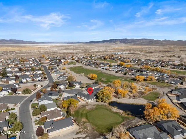 an aerial view of residential building and lake