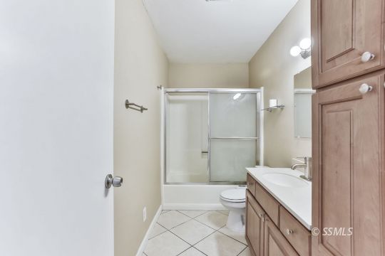 515 South Downs Street Ridgecrest, CA 93555 - Photo 22 of 31 a bathroom with a granite countertop sink a toilet and shower