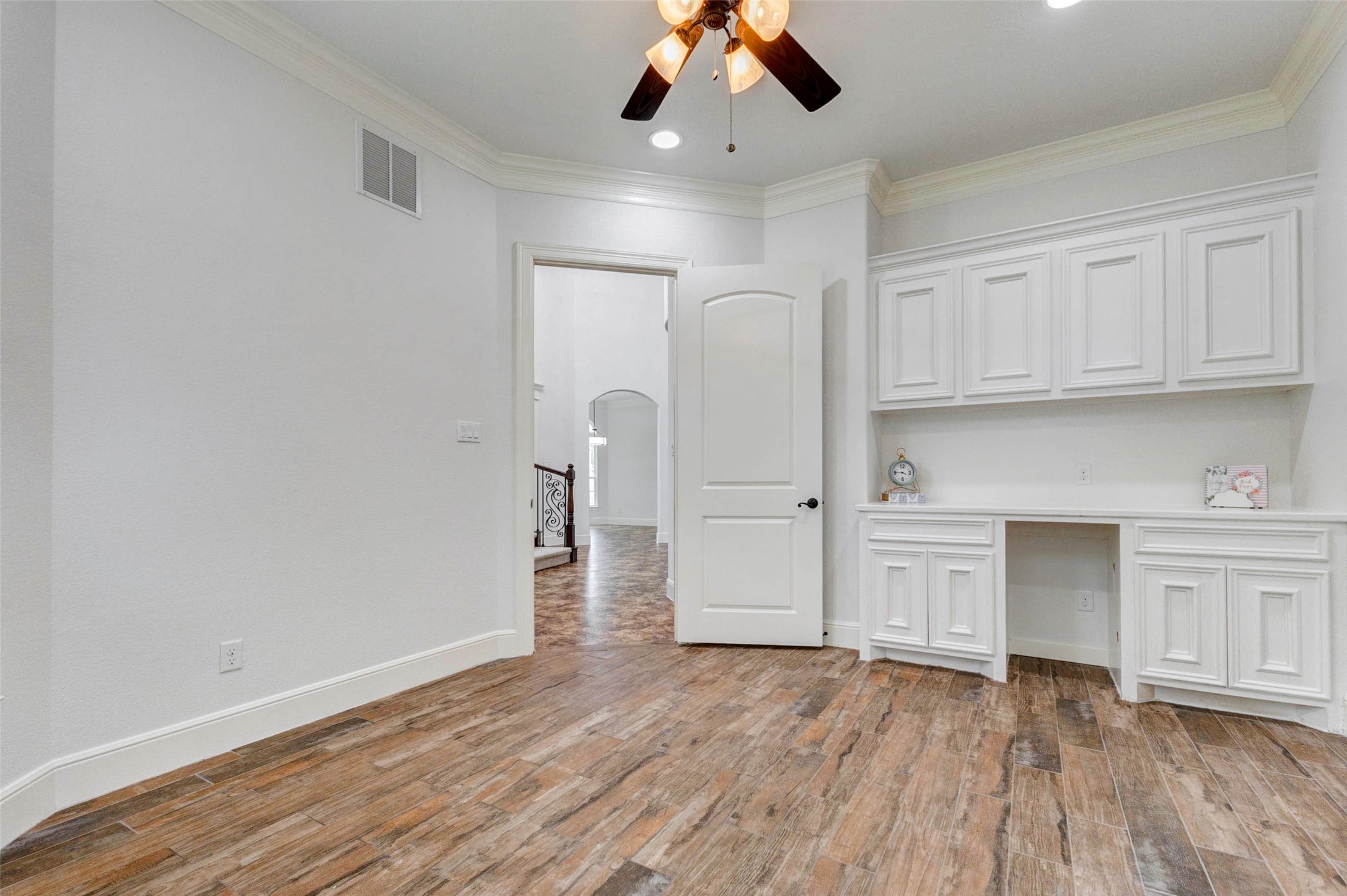 5327 Whitmore Fulshear, TX 77441 - Photo 21 of 50 Custom built-in cabinetry adds versatility to the home office, creating an ideal space for organized work or study.