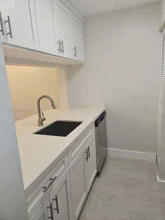 a kitchen with a sink and cabinets