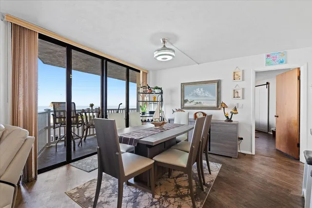 a dining room with furniture window and wooden floor