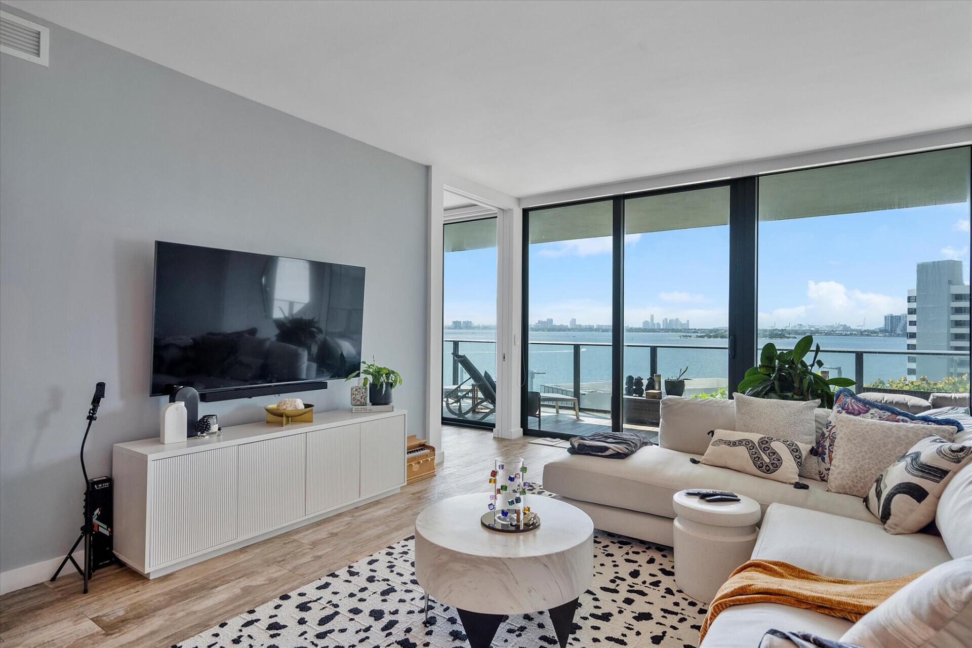 650 Northeast 32nd Street, Unit 606 Miami, FL 33137 - Photo 14 of 24 a living room with furniture and a flat screen tv