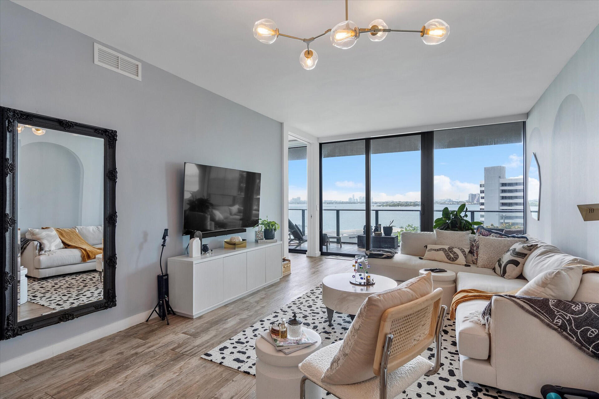 650 Northeast 32nd Street, Unit 606 Miami, FL 33137 - Photo 15 of 24 a living room with furniture and a flat screen tv