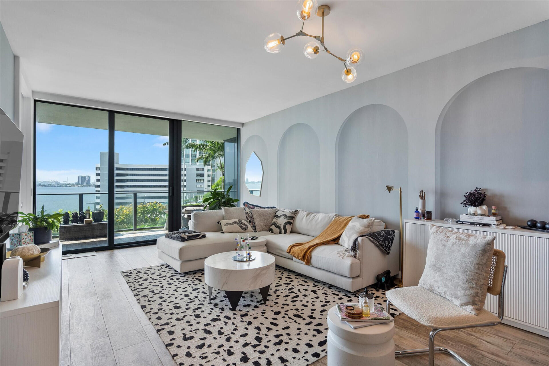 650 Northeast 32nd Street, Unit 606 Miami, FL 33137 - Photo 2 of 24 a living room with furniture potted plant and a large window
