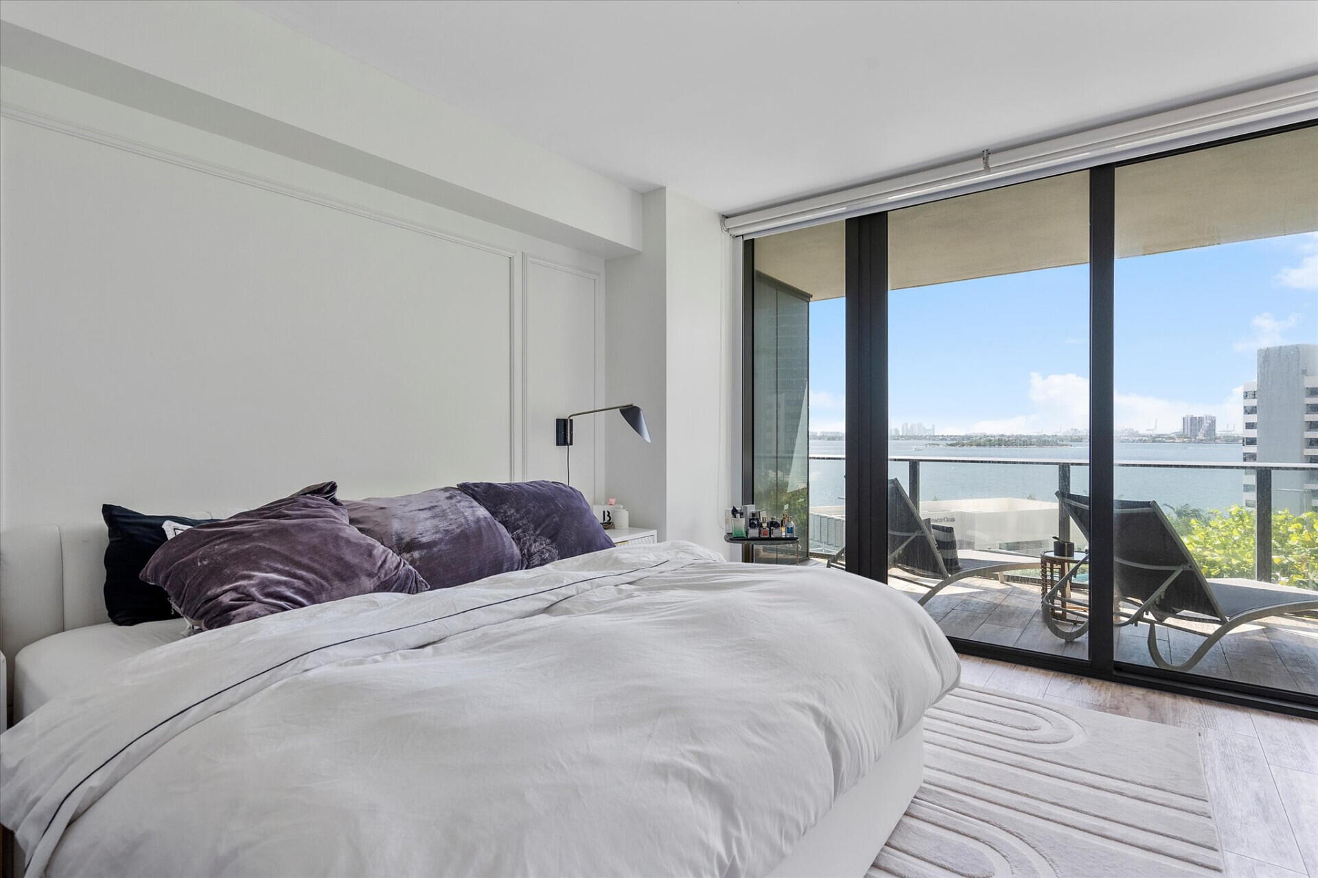 650 Northeast 32nd Street, Unit 606 Miami, FL 33137 - Photo 7 of 24 a bedroom with a bed and large windows