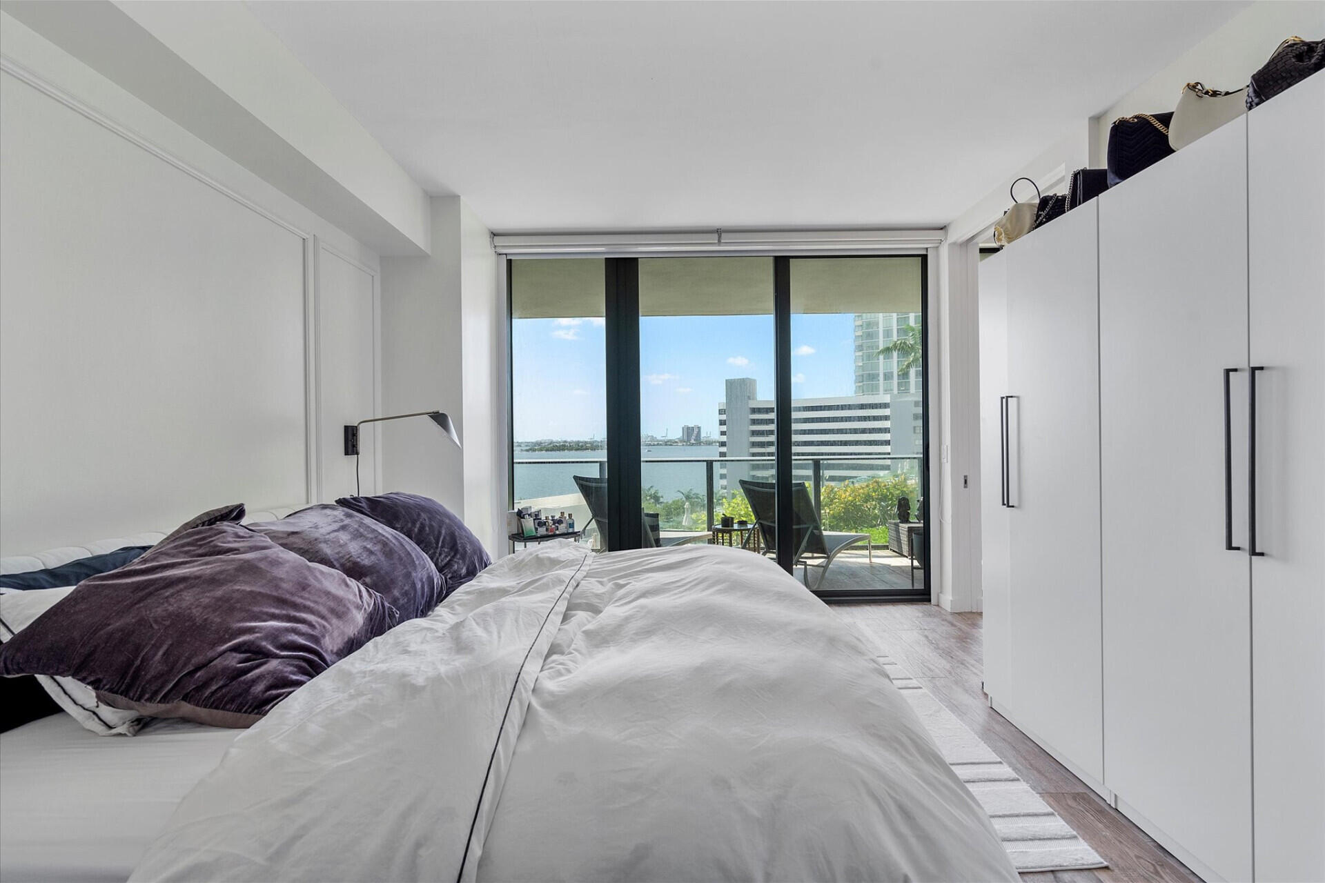 650 Northeast 32nd Street, Unit 606 Miami, FL 33137 - Photo 8 of 24 a bed sitting in a bedroom next to a window