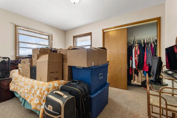 a bed room with two bed and a window