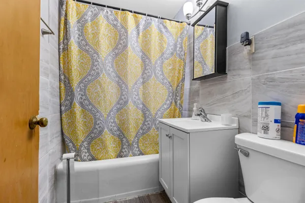 a bathroom with a sink a toilet and bathtub