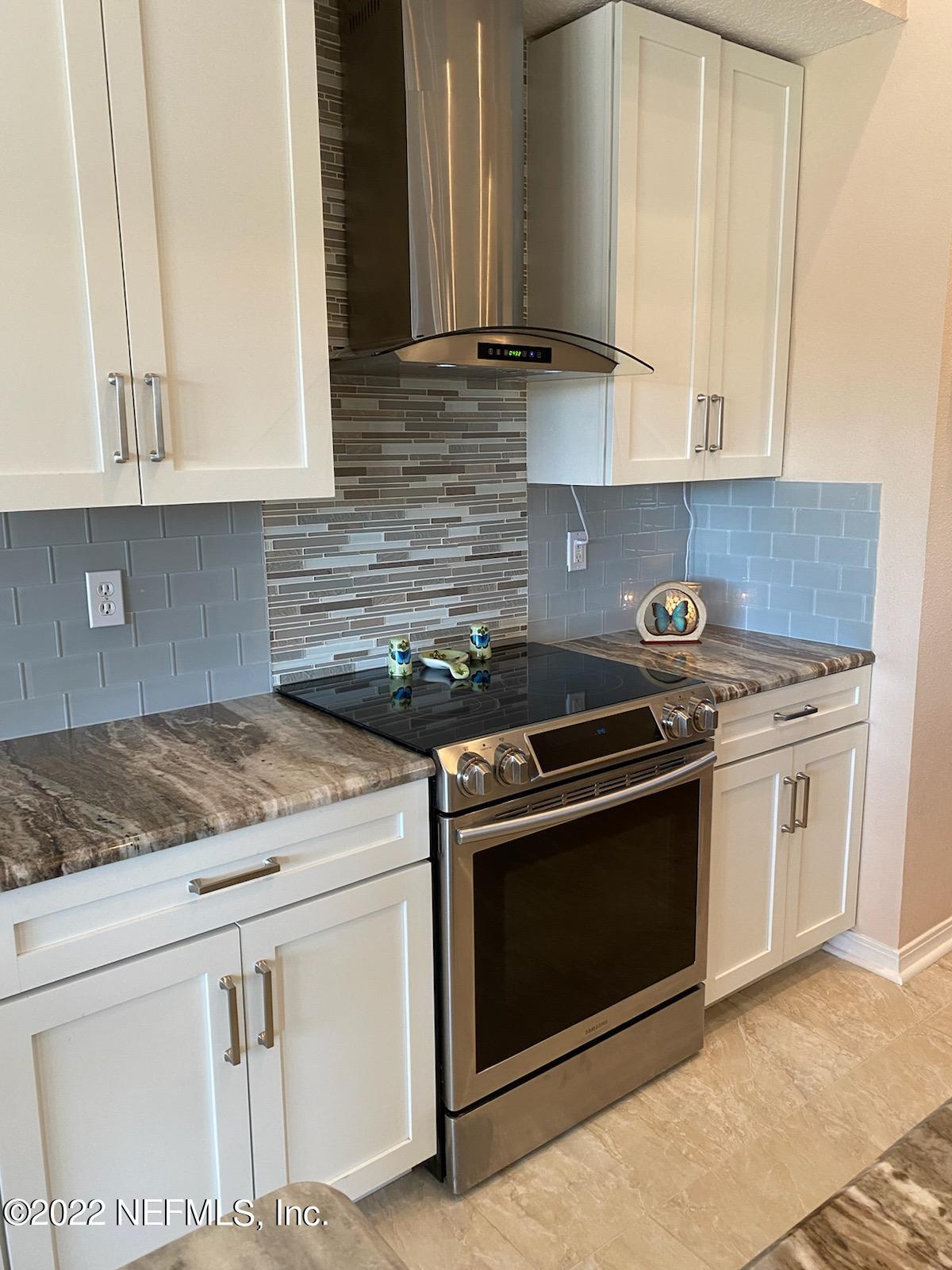 2867 Longleaf Ranch Circle Middleburg, FL 32068 - Photo 12 of 33 a kitchen with granite countertop white cabinets and white appliances