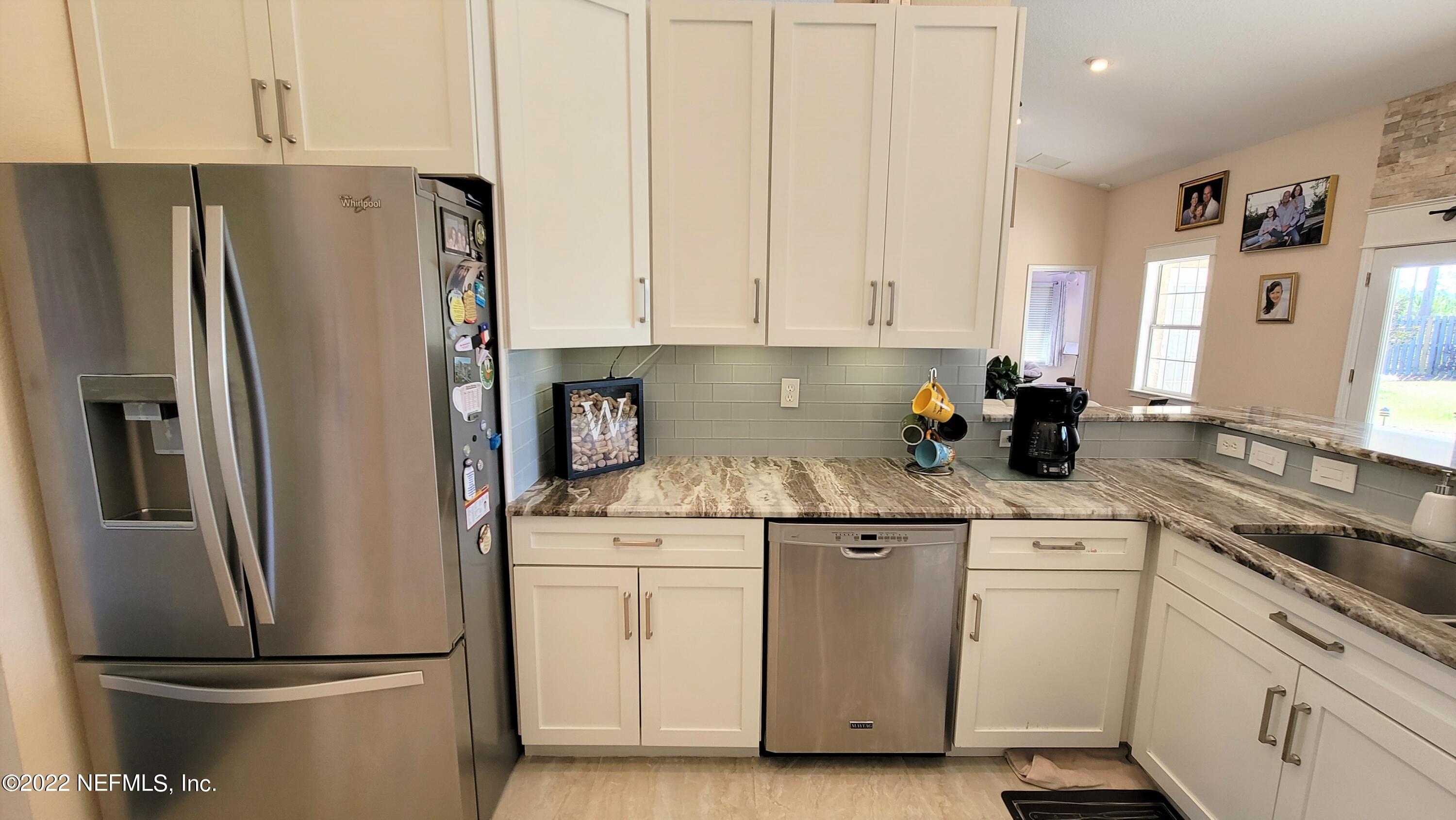 2867 Longleaf Ranch Circle Middleburg, FL 32068 - Photo 13 of 33 a kitchen with stainless steel appliances a refrigerator sink and cabinets