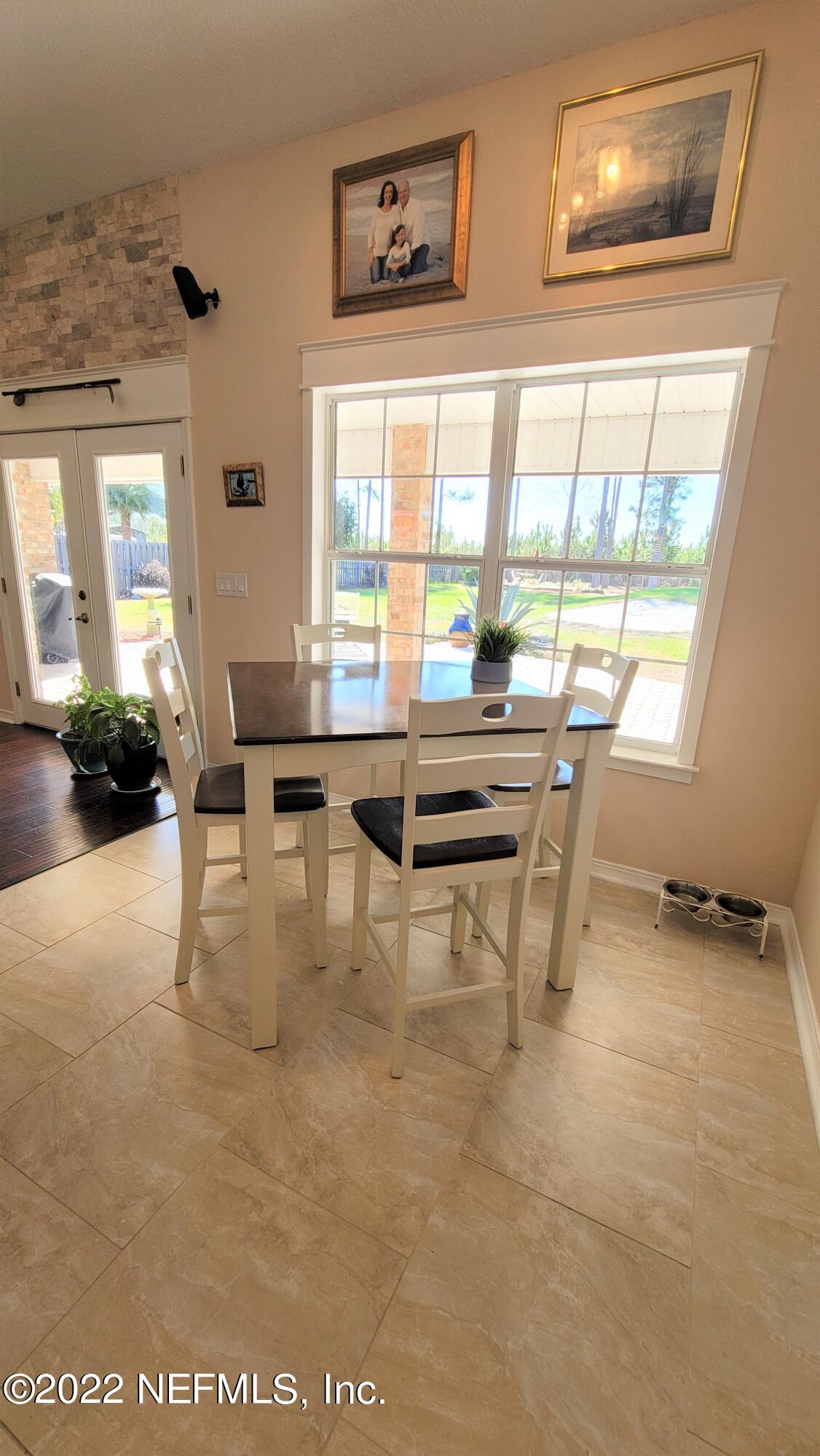 2867 Longleaf Ranch Circle Middleburg, FL 32068 - Photo 14 of 33 a view of a dining room with furniture and a window