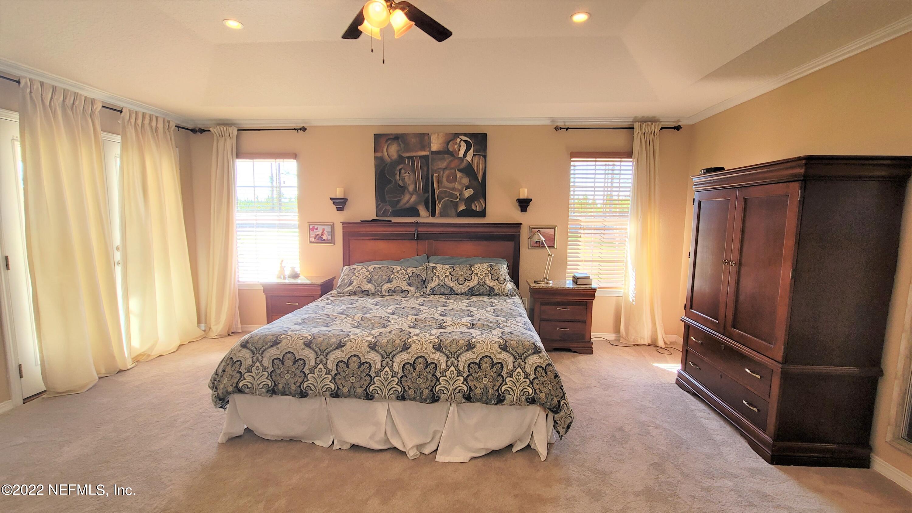 2867 Longleaf Ranch Circle Middleburg, FL 32068 - Photo 15 of 33 a bedroom with a large bed and a window