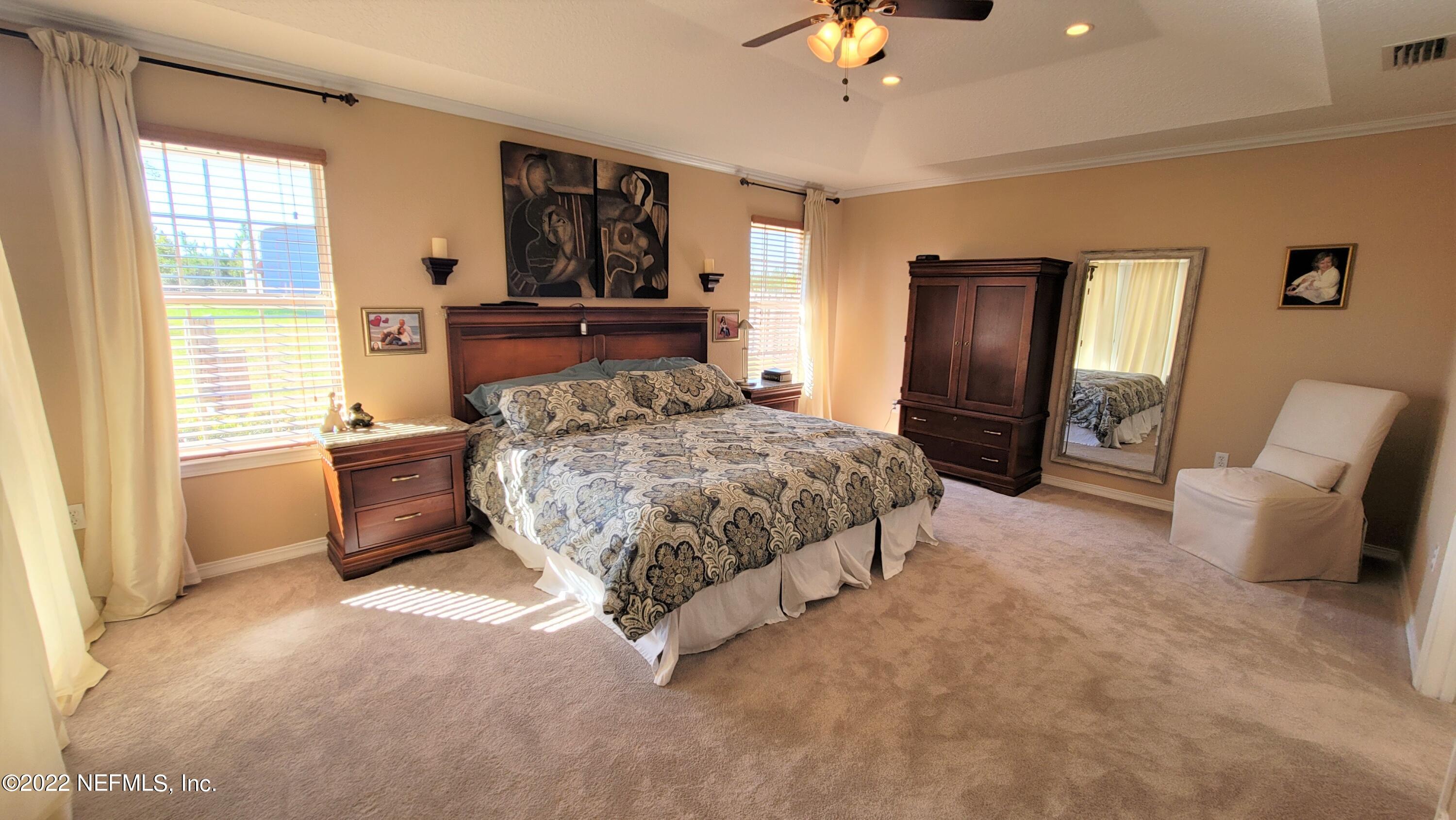 2867 Longleaf Ranch Circle Middleburg, FL 32068 - Photo 16 of 33 a bedroom with a large bed and a window