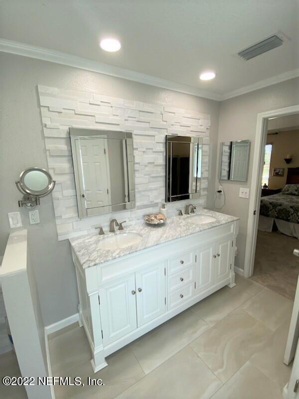 2867 Longleaf Ranch Circle Middleburg, FL 32068 - Photo 17 of 33 a bathroom with a double vanity sink and a mirror
