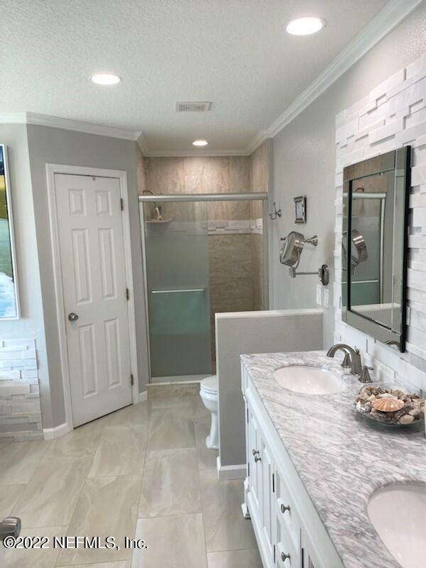 2867 Longleaf Ranch Circle Middleburg, FL 32068 - Photo 18 of 33 a bathroom with a granite countertop sink a toilet and shower