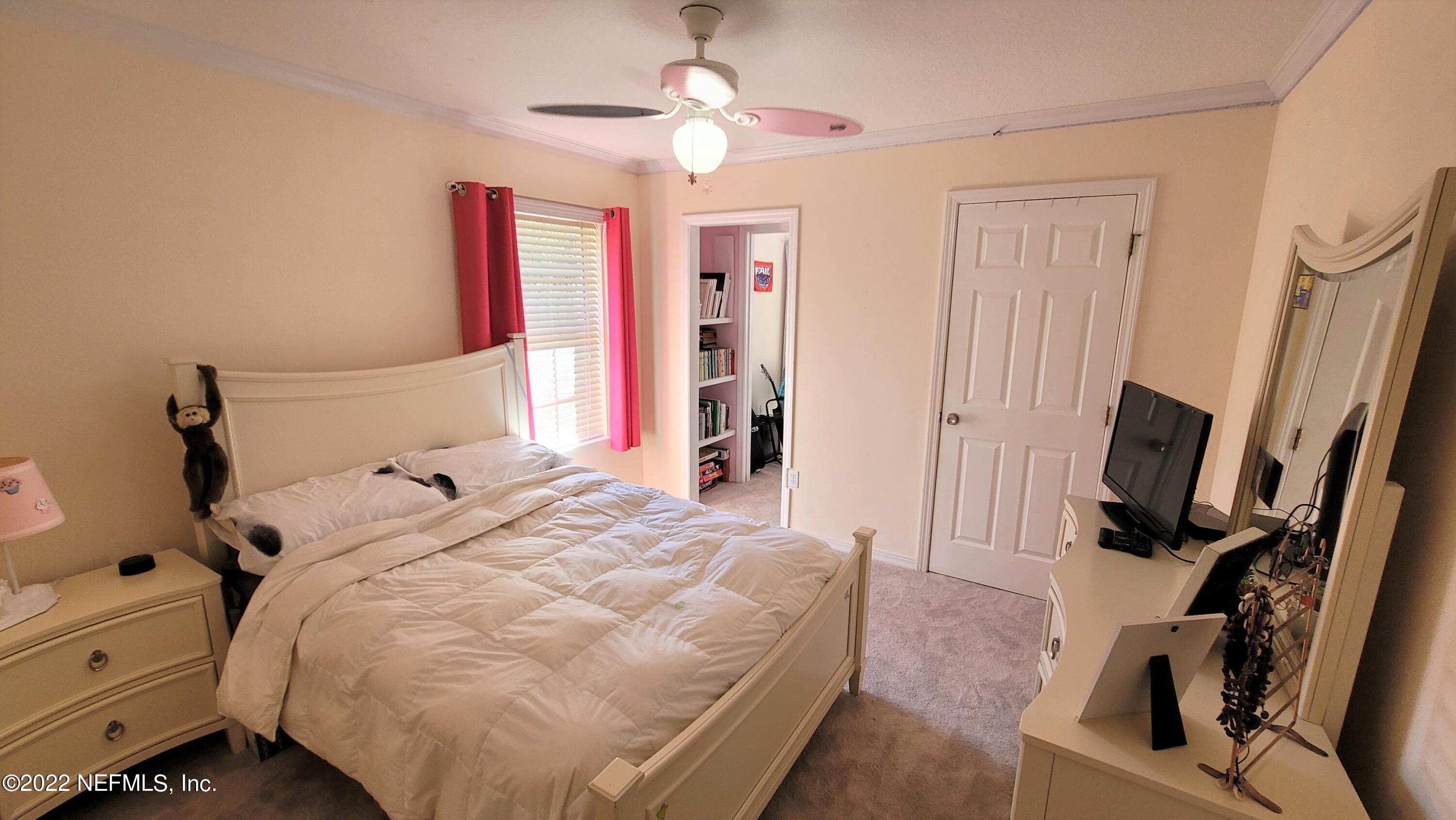 2867 Longleaf Ranch Circle Middleburg, FL 32068 - Photo 24 of 33 a bedroom with a bed a flat screen tv and a dresser