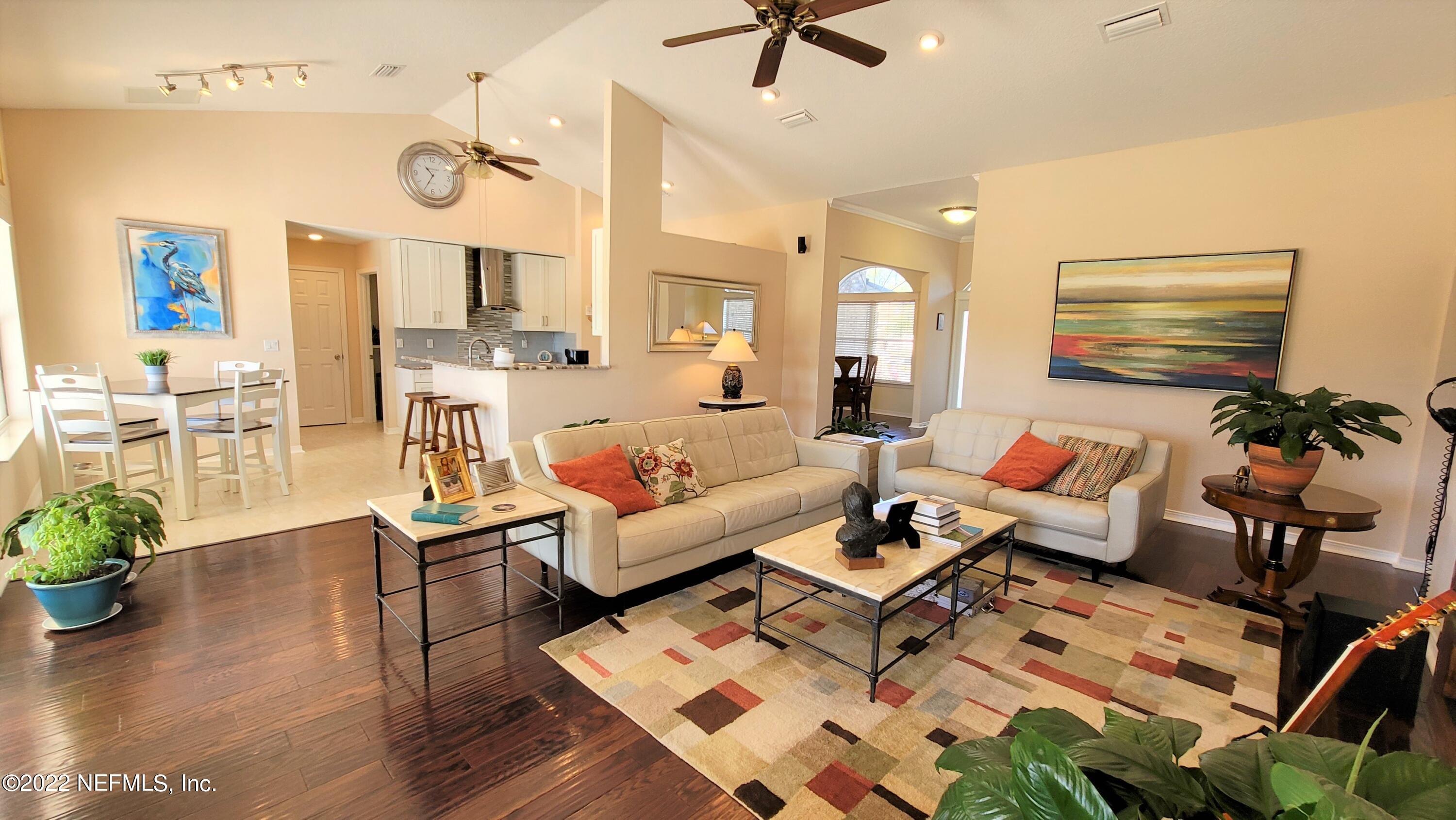 2867 Longleaf Ranch Circle Middleburg, FL 32068 - Photo 7 of 33 a living room with furniture kitchen view and a wooden floor