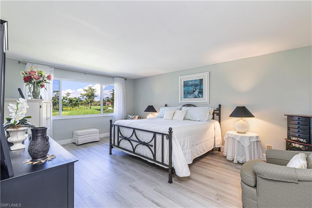 213 Memory Lane, Unit 4 Naples, FL 34112 - Photo 9 of 20 Bedroom featuring wood finished floors and baseboards