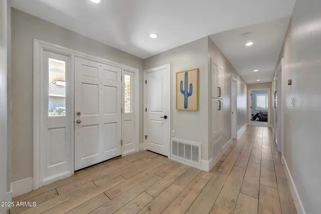 a view of a hallway with wooden floor