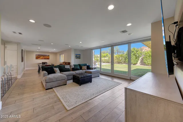 a living room with furniture tv and a large window