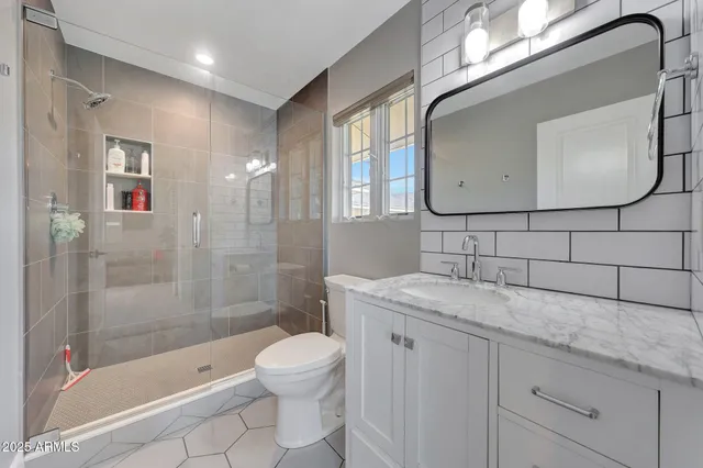a bathroom with a granite countertop sink a toilet and bathtub